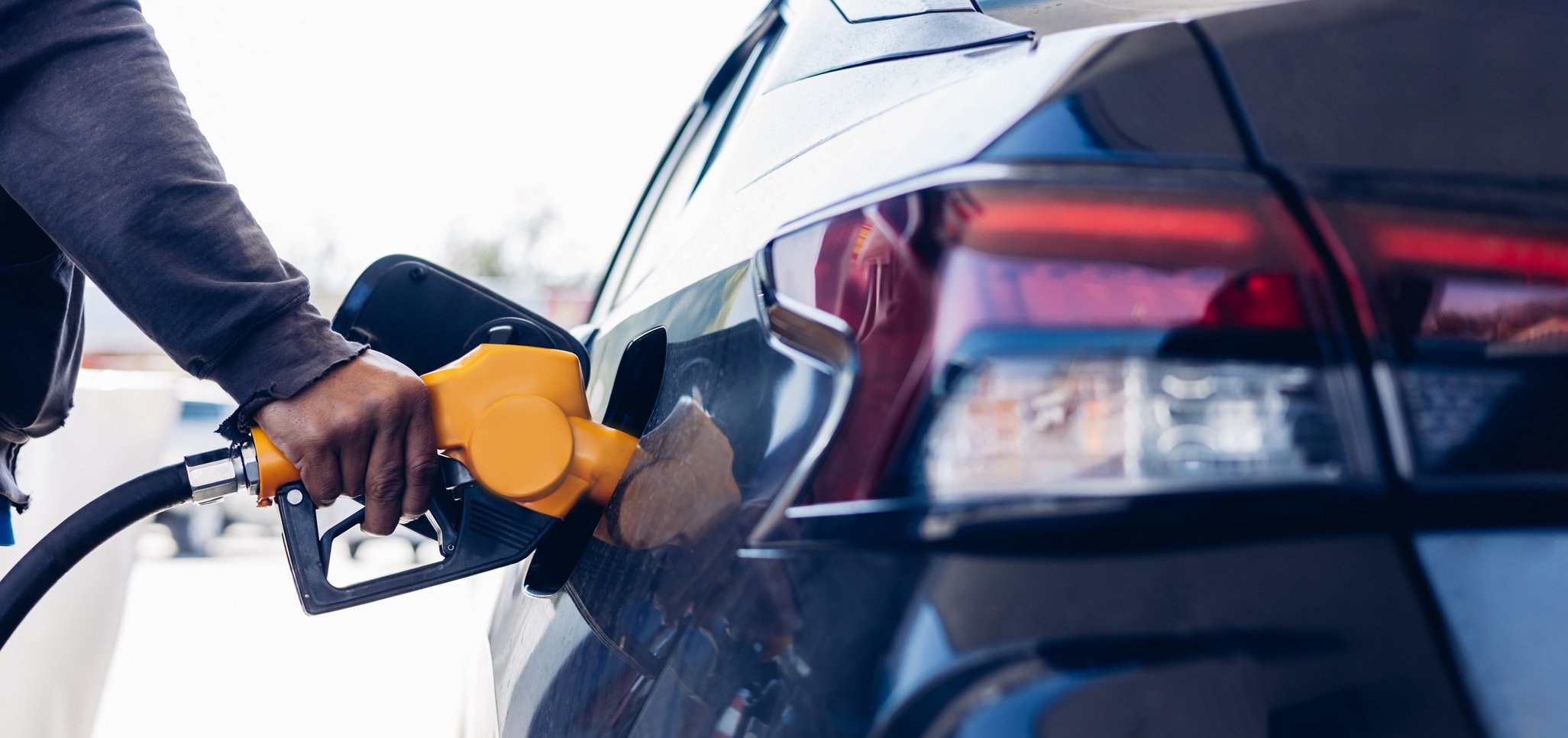 Man Refill and filling Oil Gas Fuel at station. Gas station - re